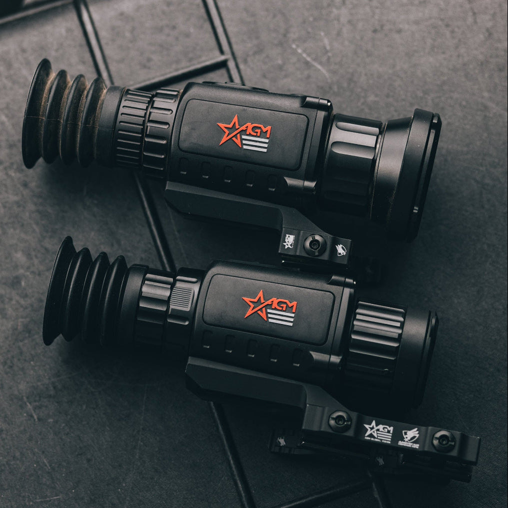 Two black thermal imaging devices with a red star logo on a dark surface